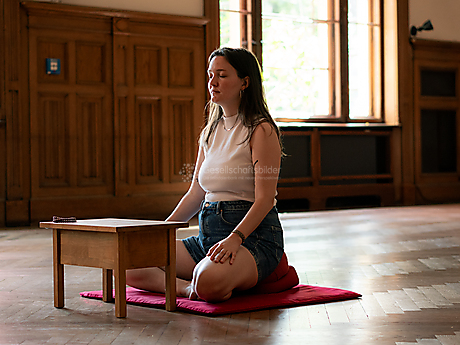 Beyond The Frame: Junge Perspektiven auf Vielfalt im Glauben - Frau meditiert im Schreinraum